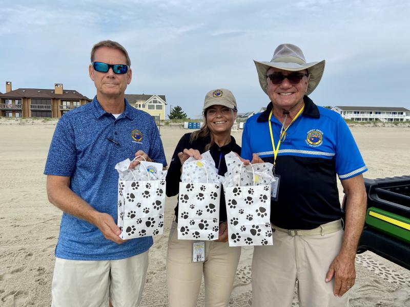 Owners who purchase the limited-edition lifetime dog tag receive a gift bag with dog treats, a tennis ball and information on keeping dogs safe and healthy. Holding the gift bags are (l-r) Town Manager Bill Zolper, Parking and Code Enforcement Supervisor Merle Leonard and Code Enforcement Officer Vince Carannande.